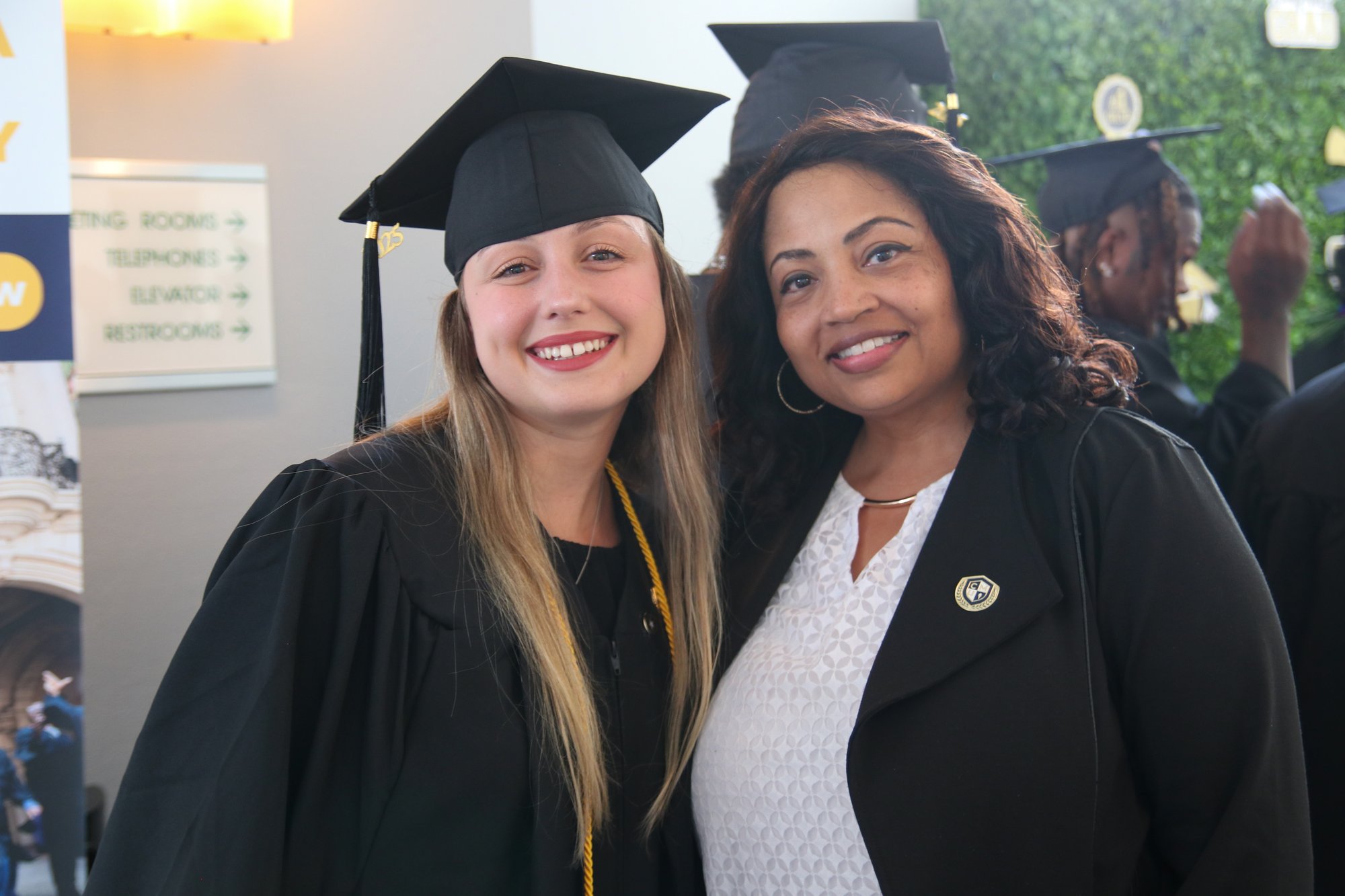CalMU graduates with staff member at commencement celebration