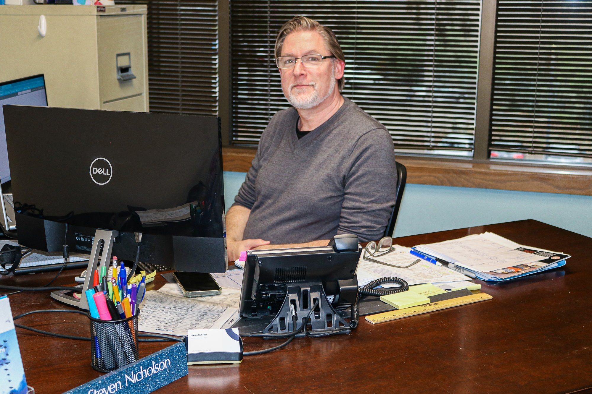 calmu-admissions-manager-sitting-at-desk