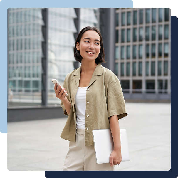 Young professional with laptop and smartphone in business district