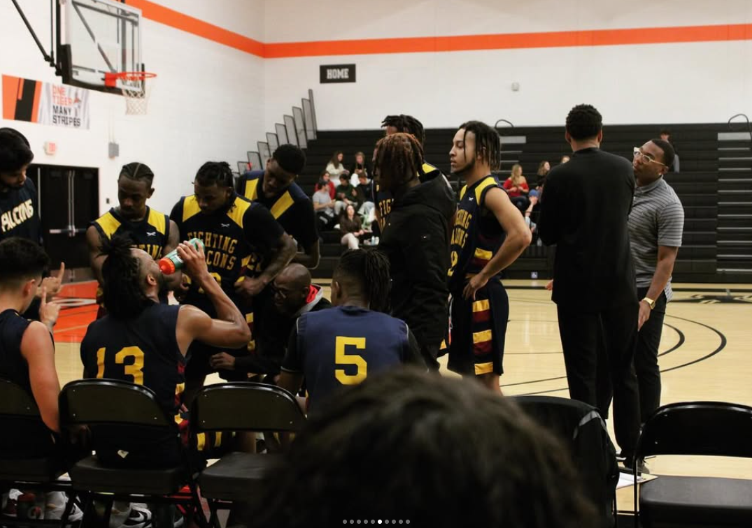 CalMU Falcons basketball team during timeout huddle with coaches