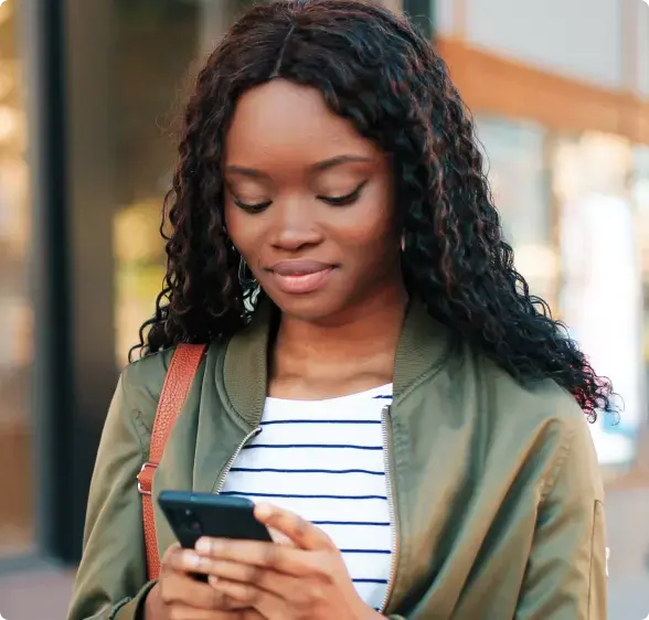 CalMU student checking her phone between classes